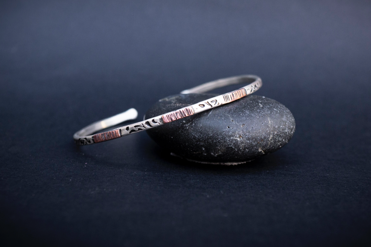 Mixed Metal Cuff Bracelet for Men.  Handmade in the Honey Bee Metals Studio.  It is textured sterling silver with copper accents.