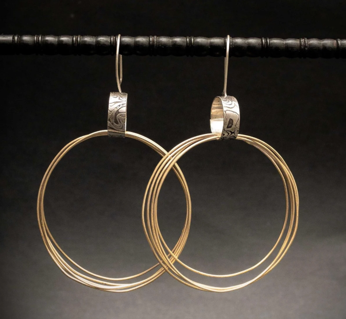 large mixed metal hoop earrings with a 3 inch drop length.  6 thin hoops on each earring that are made with jewelers brass.  they are held together with a textured and oxidized sterling silver hoop.  handmade in the Honey Bee Metals studio.