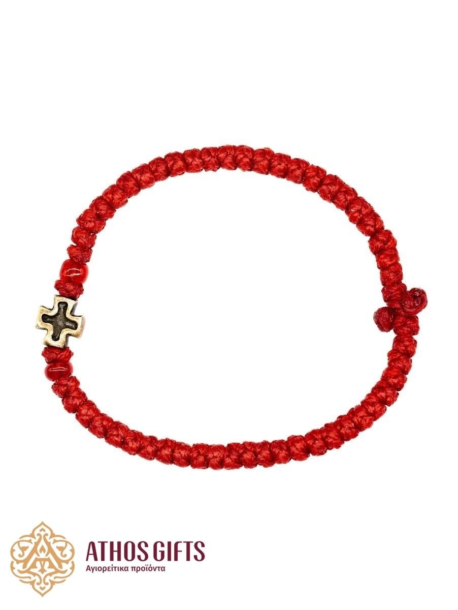 Red woven bracelet with a silver cross.