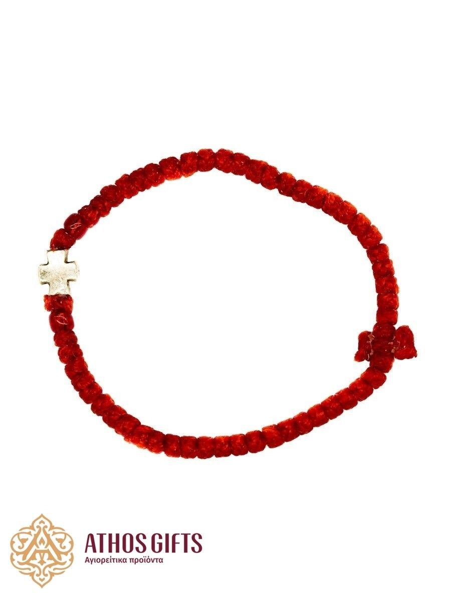 Red woven bracelet with a silver cross.