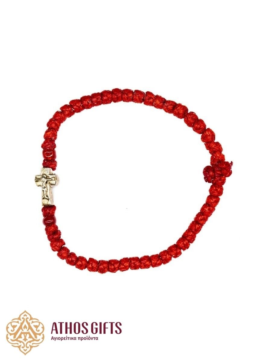 Red woven bracelet with a silver cross.