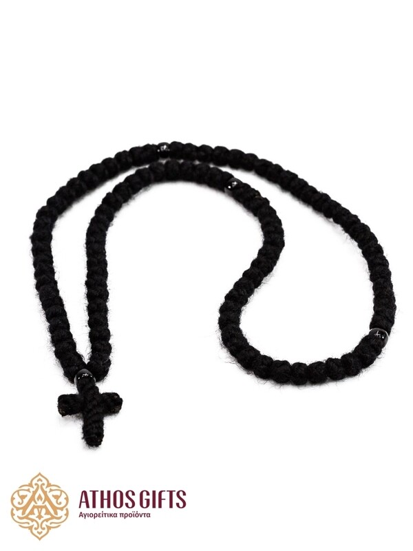 Handmade woven prayer rope with a cross.