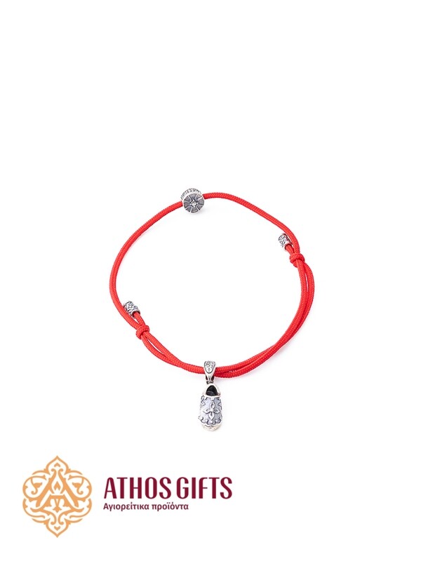 A red bracelet with a silver slipper of Saint Spyridon.