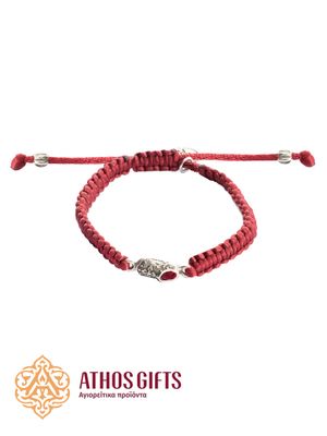 A red bracelet with a metal slipper containing a fragment of St. Spyridon’s slippers.