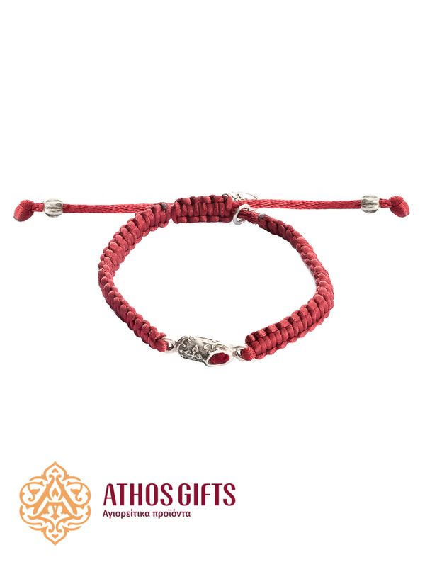 A red bracelet with a metal slipper containing a fragment of St. Spyridon’s slippers.