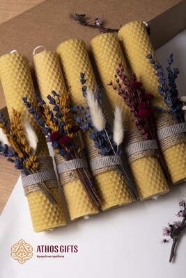 Handmade candle made of natural beeswax with decoration of dried flowers.