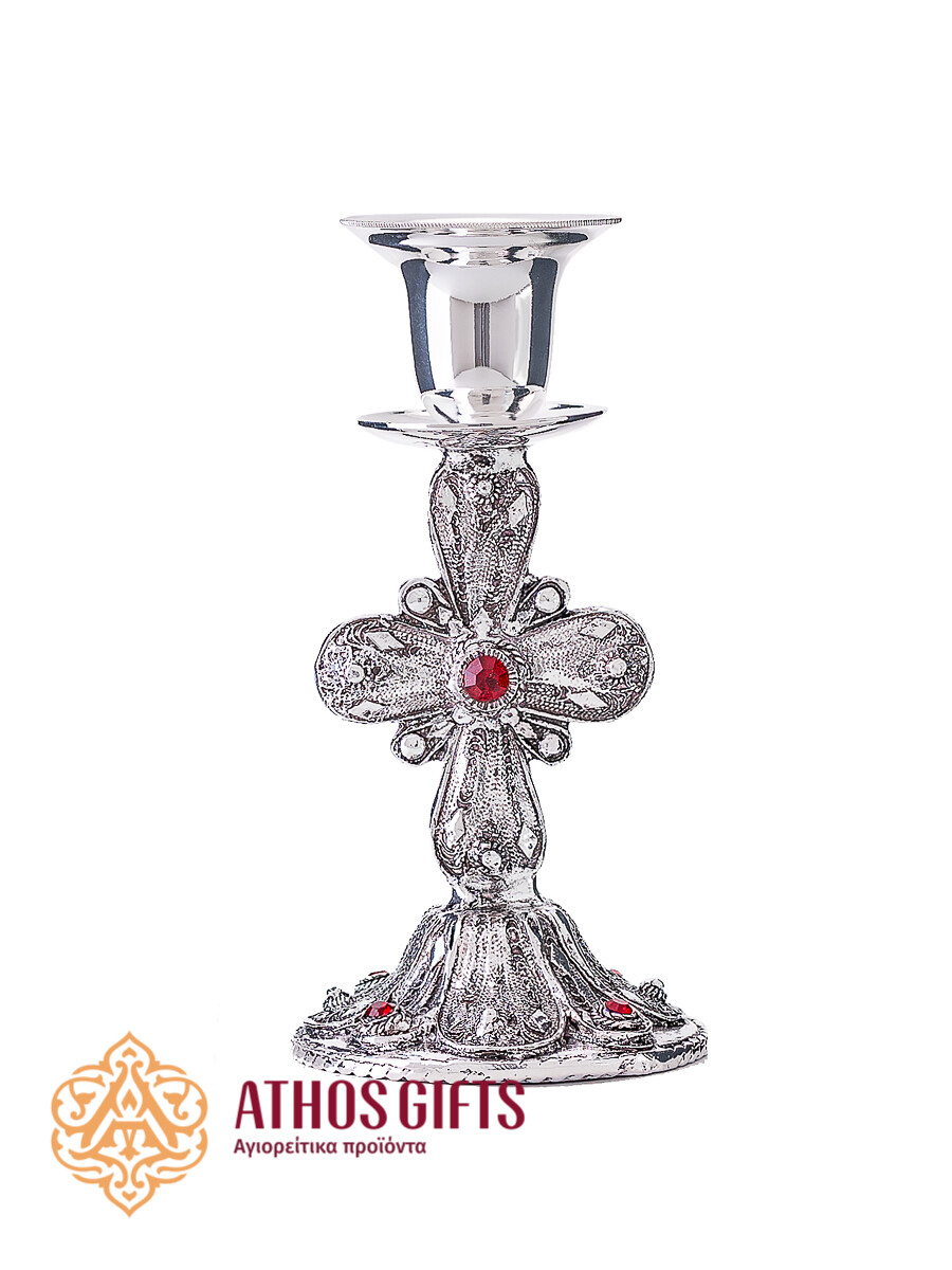 Metal candle holder with a carved cross adorned with a red rhinestone