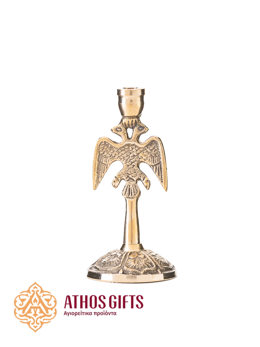 Metal candle holder with a relief image of a golden double-headed eagle.