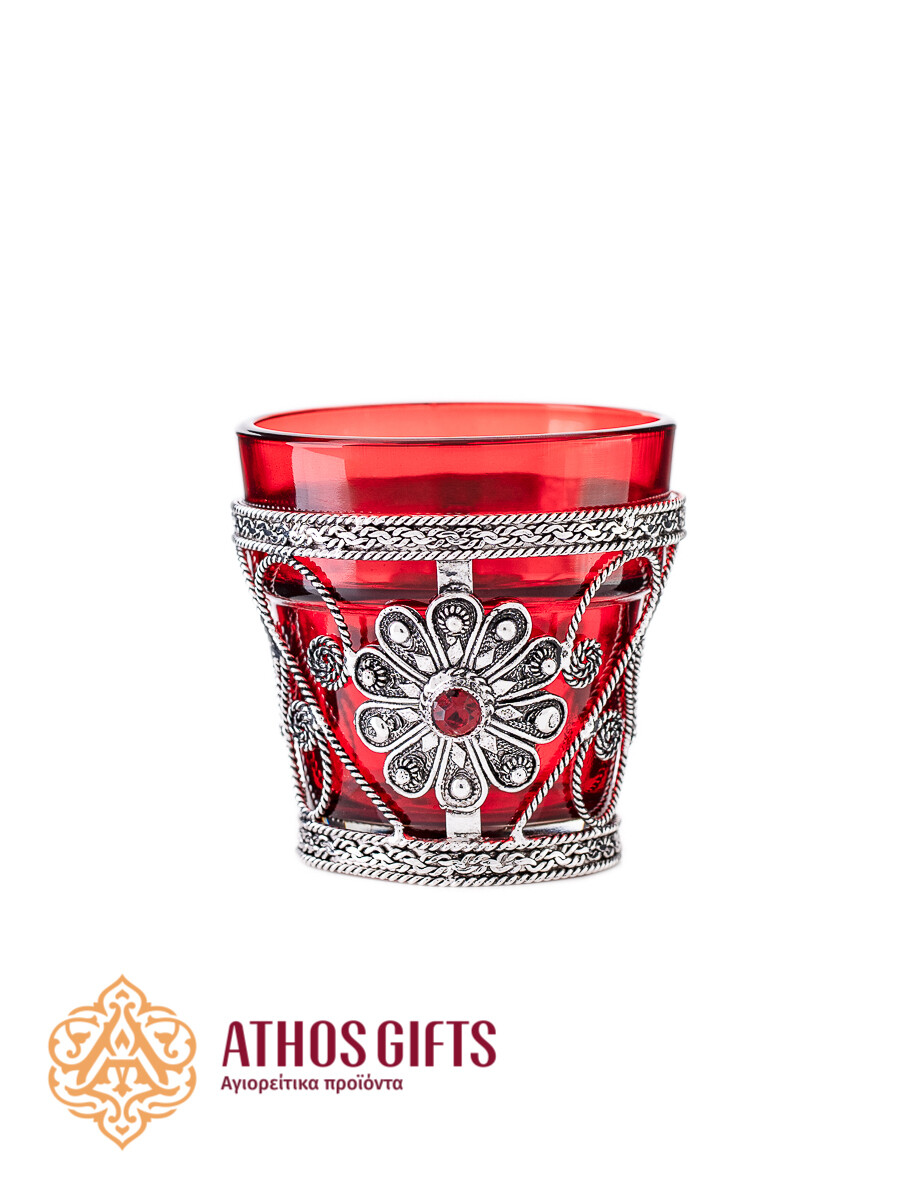 Table oil lamp for home use, made of red glass in a metal frame.