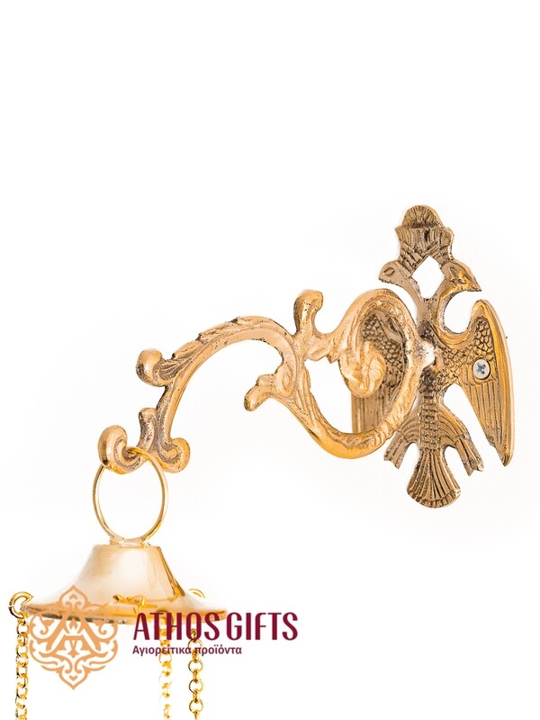 Wall-mounted bracket for a hanging vigil lamp in gold color.