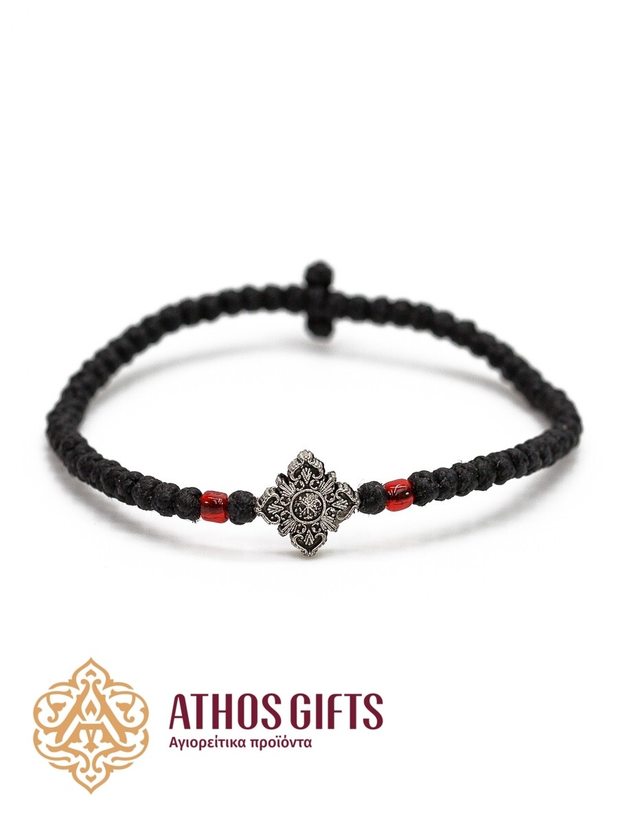 Woven bracelet with a cross and red beads