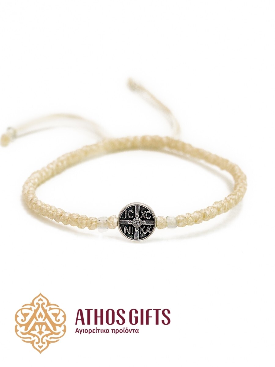 White braided bracelet with white beads and an icon on a metal insert.