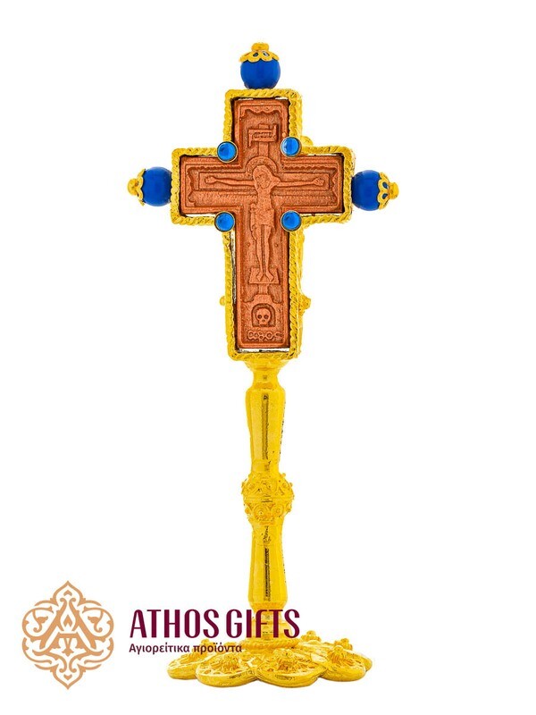 Ceramic tabletop cross in a metal frame with dark blue beads.