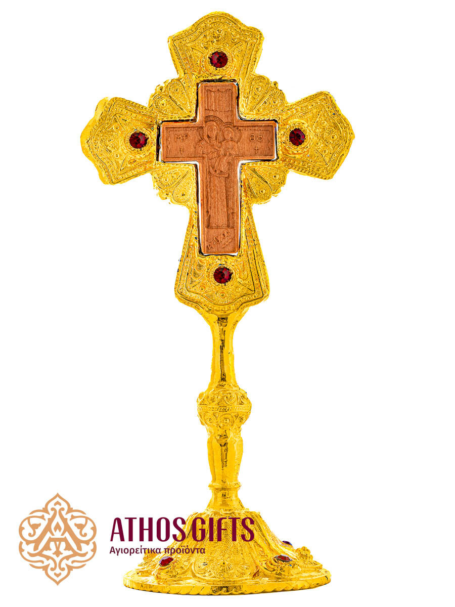 Ceramic tabletop cross in a metal frame with red beads.