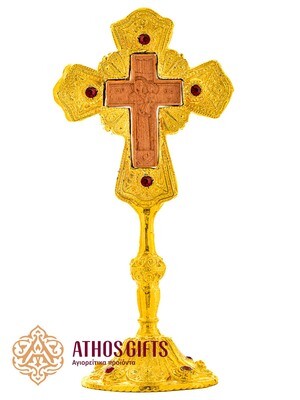 Ceramic tabletop cross in a metal frame with red beads.