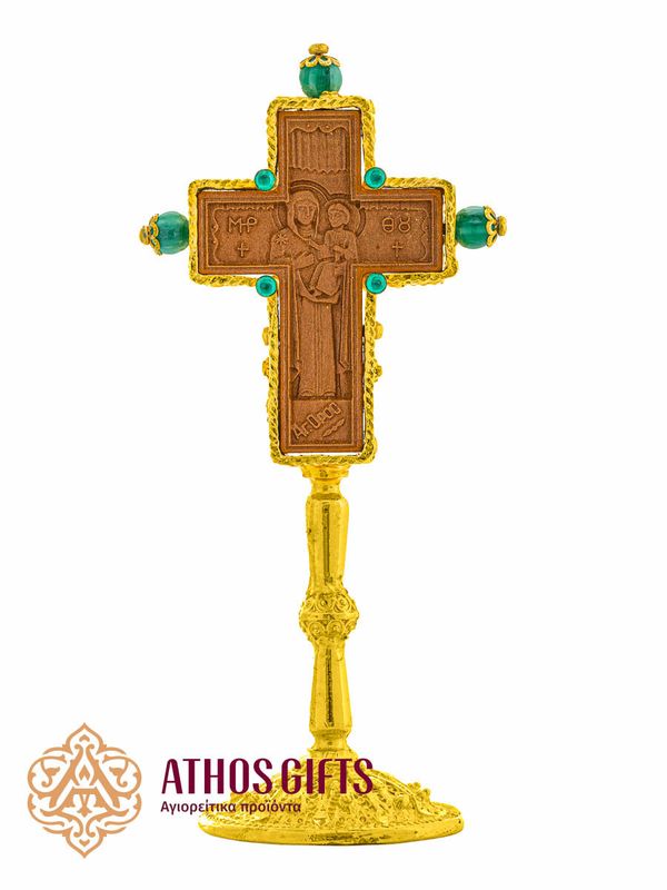 Tabletop ceramic cross in a metal frame with green beads.