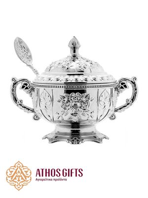 Silver-colored metal box for storing incense with a spoon