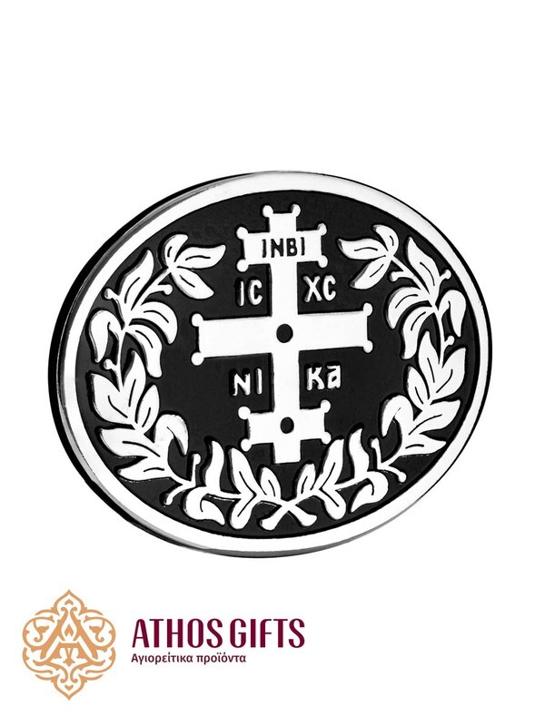 Metal belt buckle with an engraved image of a cross and the inscriptions “INBI” and “IS XS NIKA”.