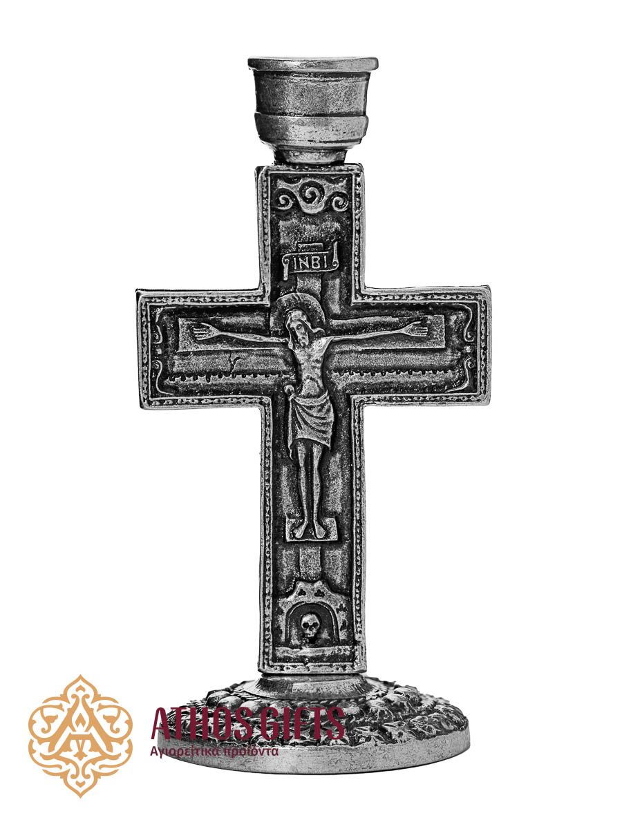 Silver-colored metal cross-shaped candle holder with images of the Crucifixion and the Mother of God