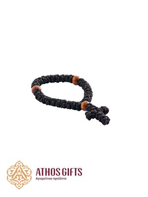 Children’s woven prayer rope with a cross and wooden beads.