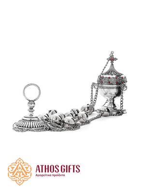 A silver-colored censer for incense.