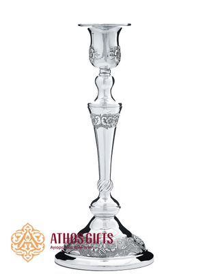 Metal candlestick for a single candle, decorated with a carved ornament.