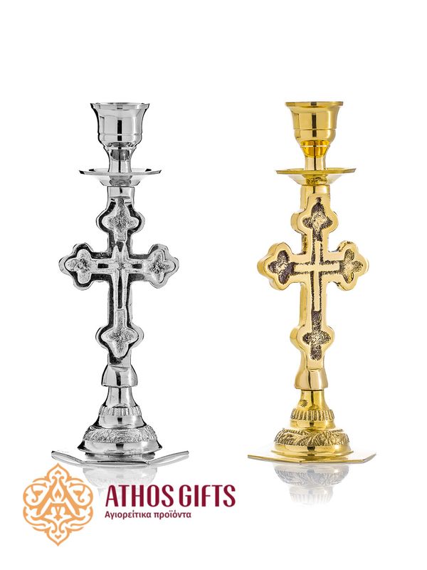 Silver- or gold-colored metal candle holder with a cross and carvings