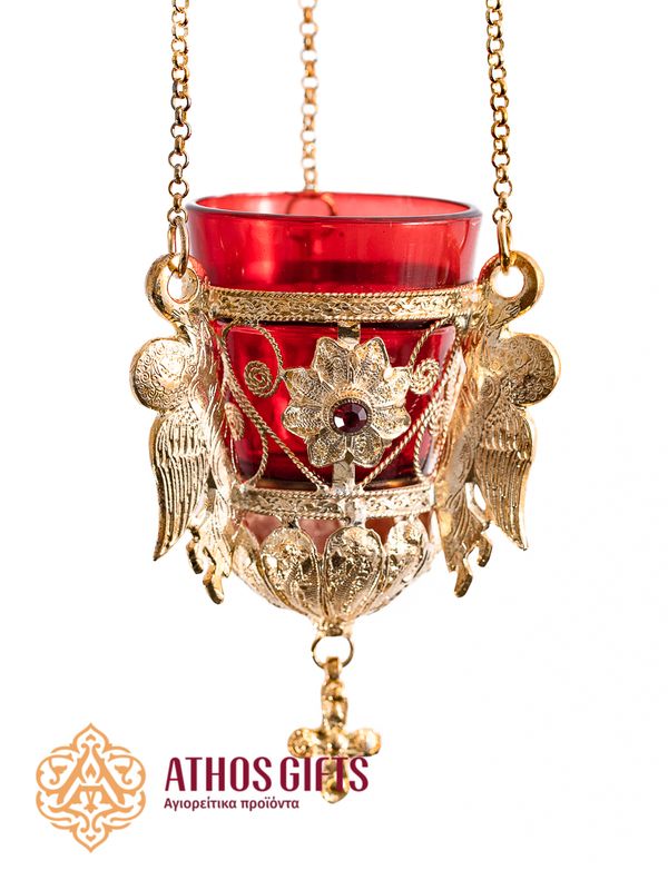 Hanging glass lampada made of red glass in a metal frame with carved ornamentation.