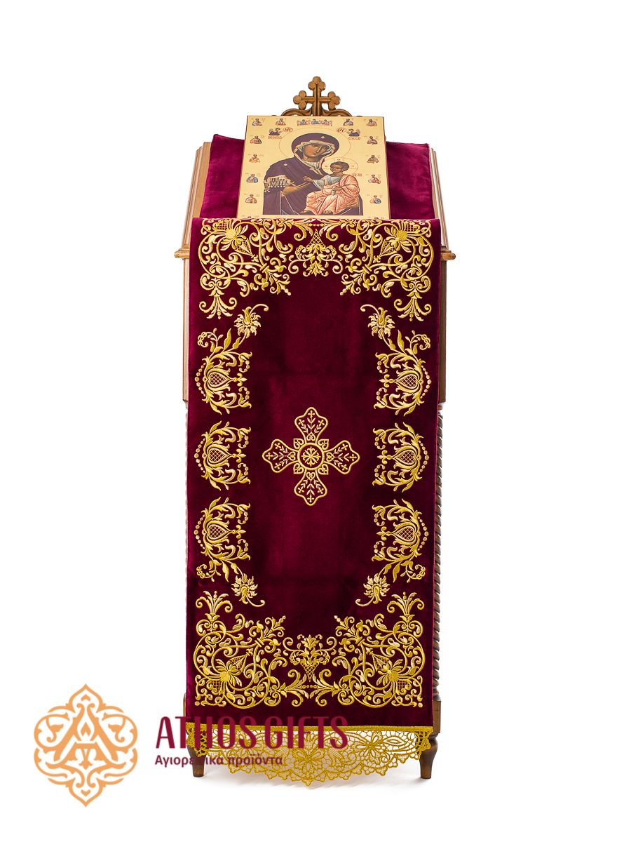Burgundy velvet analogion cover with embroidery. In the center, a cross is depicted, framed by a floral ornament.