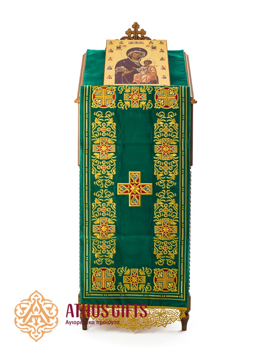 Green velvet analogion cover with embroidery, with a cross embroidered in the center.