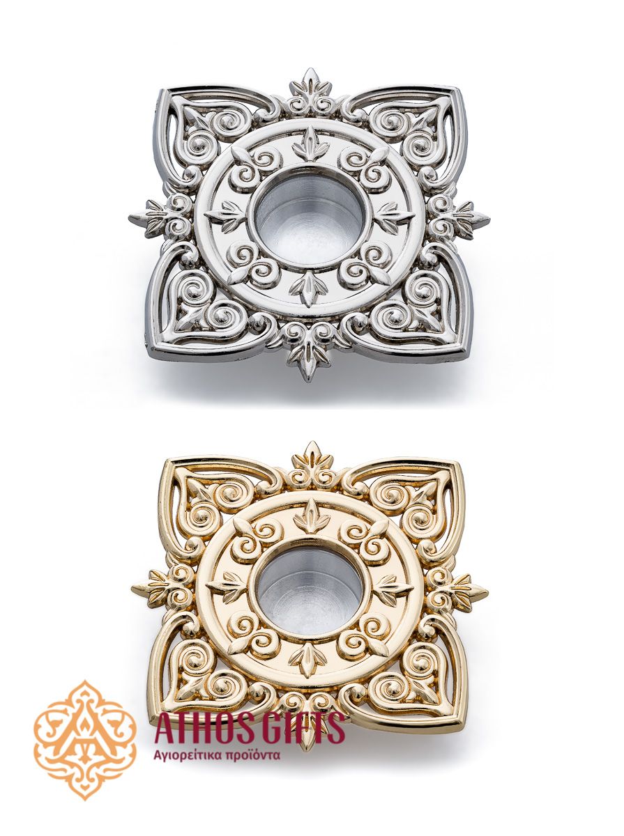 A miniature metal reliquary with a viewing window, decorated with a floral ornament.