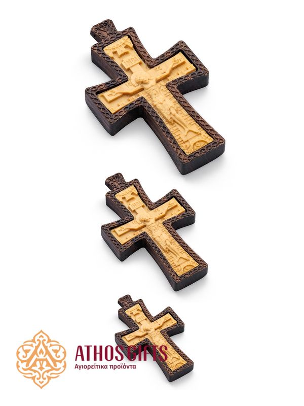 Carved wooden cross made of boxwood, placed in a frame of dark walnut wood.