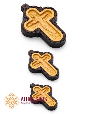 Carved wooden cross made of boxwood, placed in a frame of dark walnut wood.