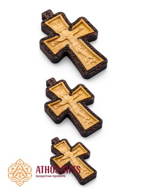 Carved wooden cross made of boxwood, placed in a frame of dark walnut wood.