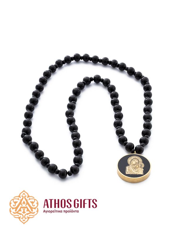 Prayer beads made of black wood with a relief metal image of the Mother of God.