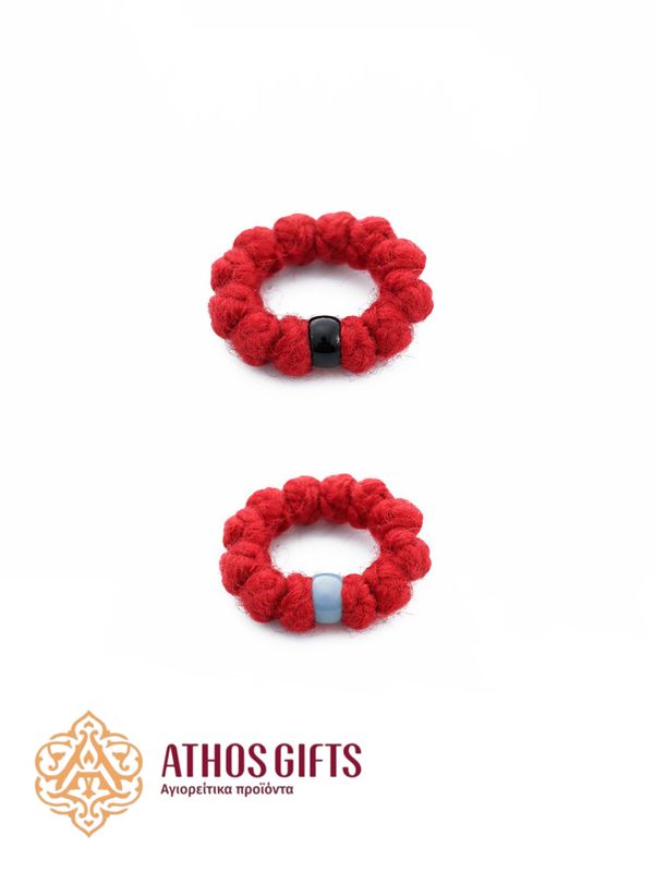 Red wool prayer ring-rope. It consists of 12 knots and a plastic rhinestone.