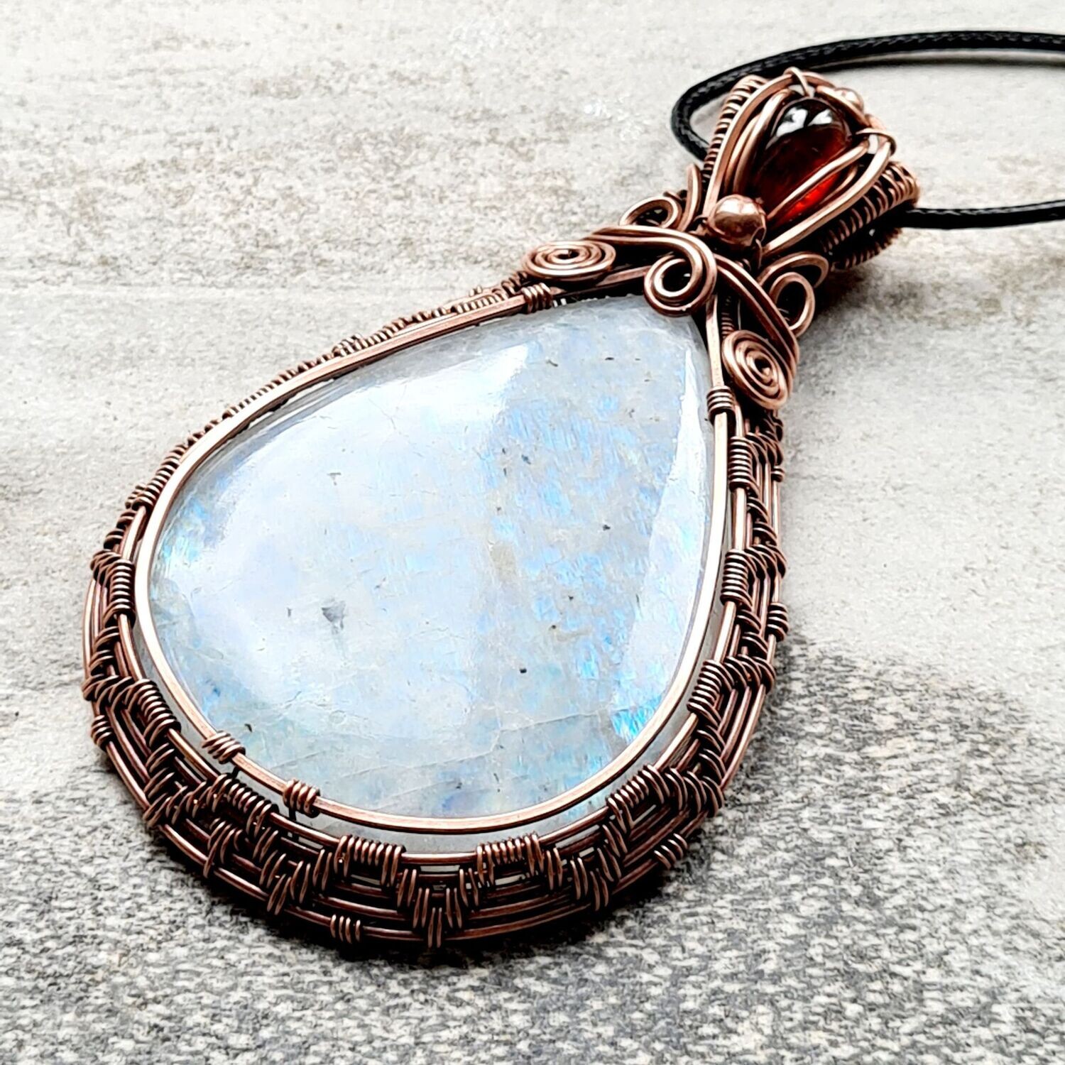 Behemoth Rainbow Moonstone with Garnet accents and beads pendant with chain.