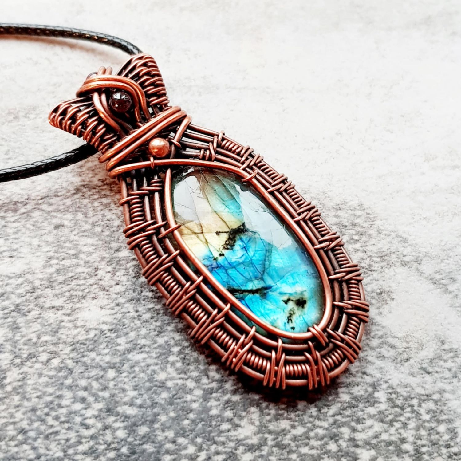 Flashy Labradorite with garnet accents pendant with chain.