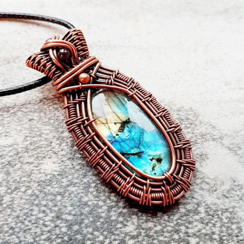 Flashy Labradorite with garnet accents pendant with chain.