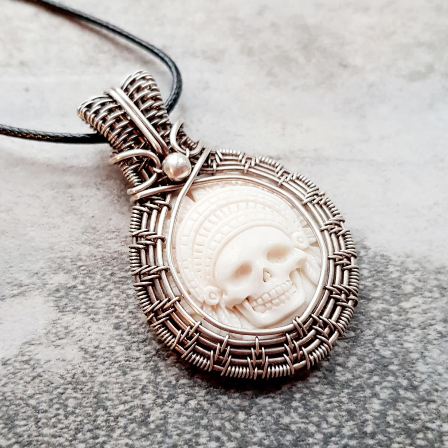 Carved Bison Bone Skull and Headdress pendant with chain.