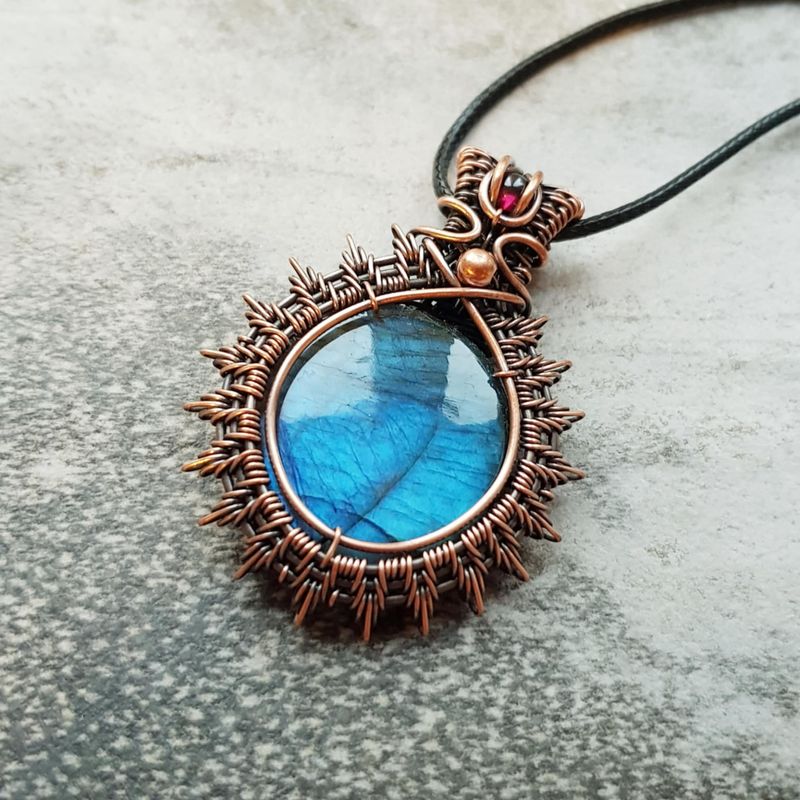 Large blue flashy Labradorite with garnet accent pendant with chain.