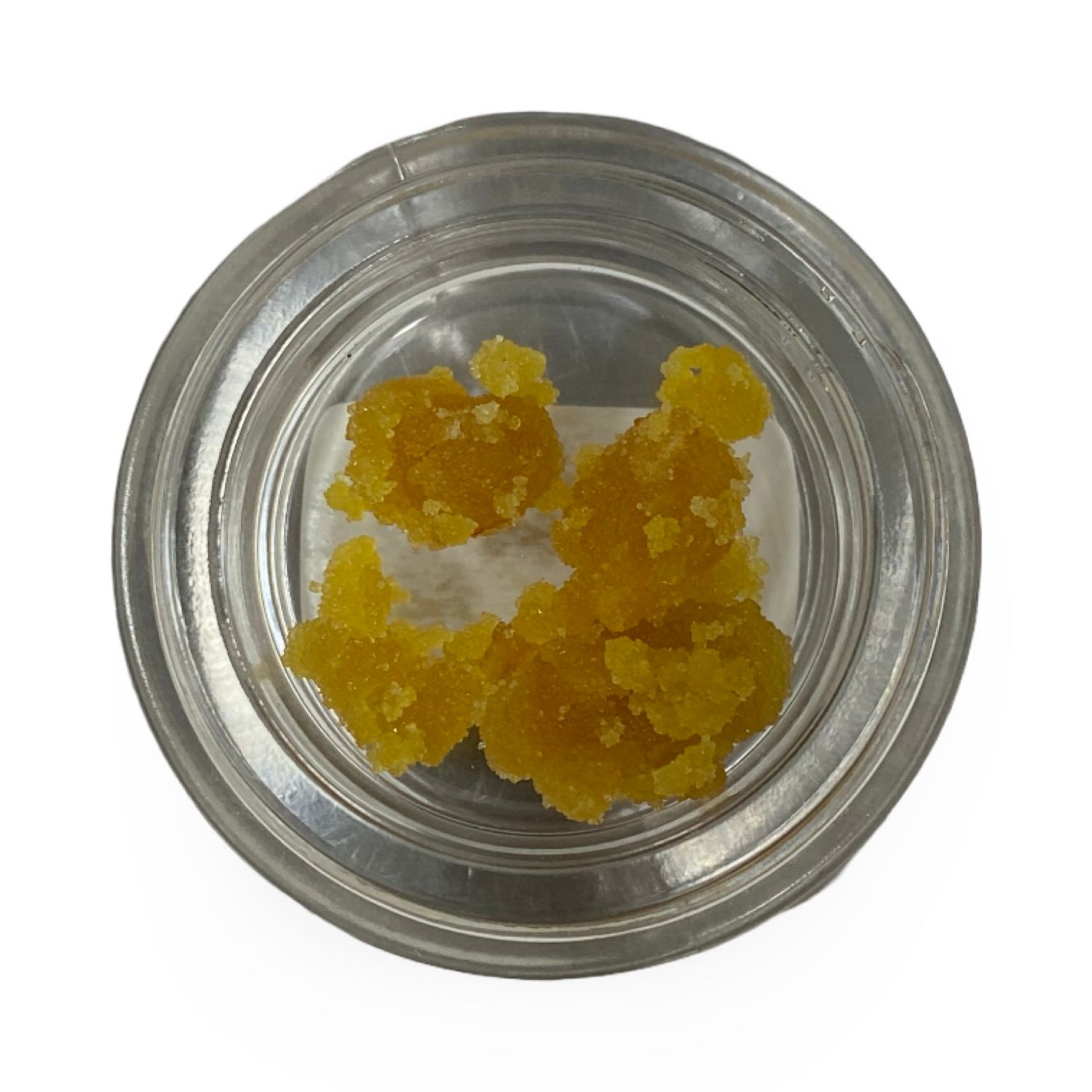 Close-up of Tropical Runtz Crumble in glass container with golden crumble texture