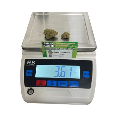 Durban x Pound Cake eighth ounce on scale – top-shelf hybrid weed with sweet berry aroma and frosty buds