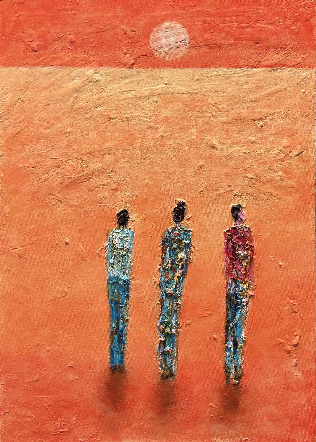 Trinity by Irish artist Anthony Carey — a 70 × 50 cm mixed-media painting featuring three abstracted human forms standing beneath a hazy sun. The figures are formed with layered acrylic and plaster against a richly textured orange and ochre backdrop, suggesting themes of unity, sacred triads, and spiritual presence. Framed in a black wooden float frame and ready to hang.