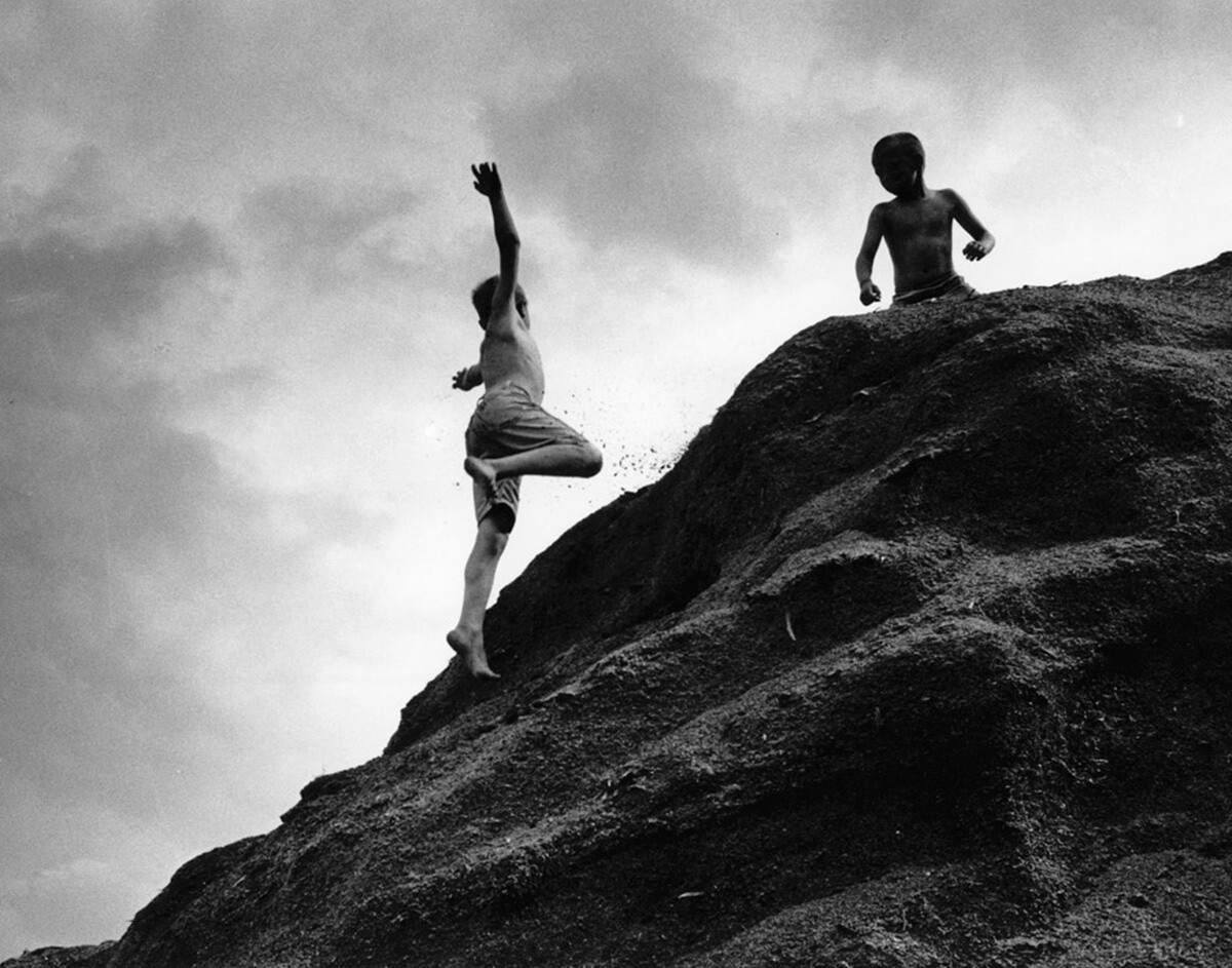 Boys Jumping Off Sawdust Pile