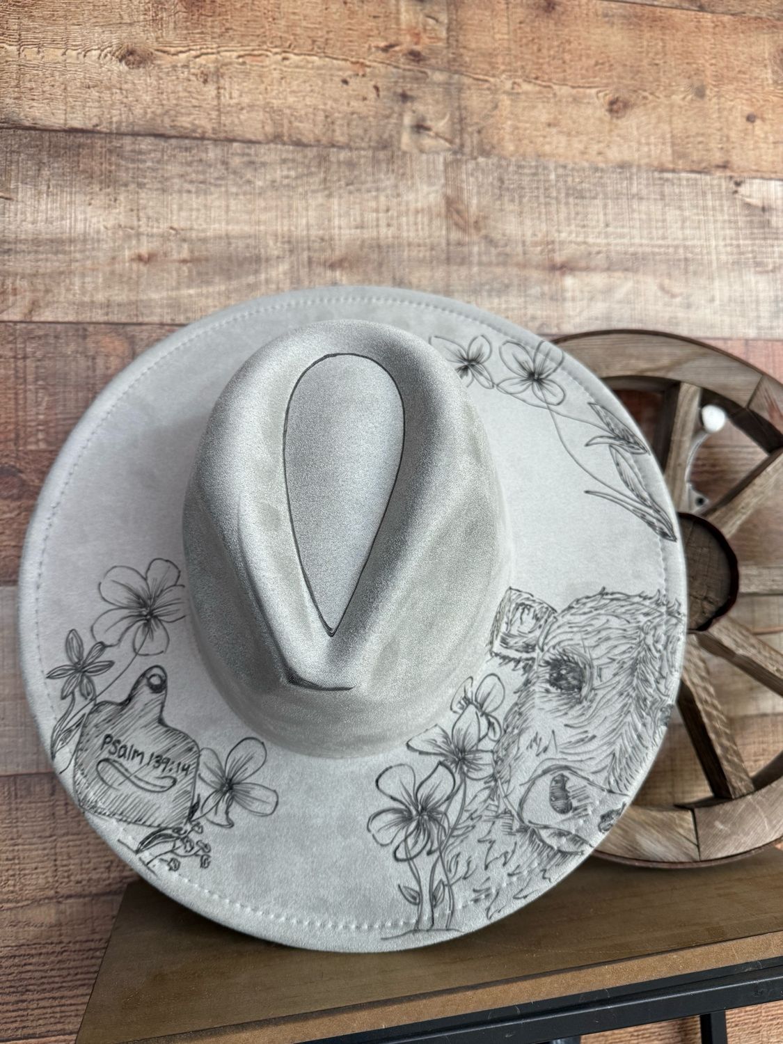 Hand burned light gray suede cowboy hat featuring a detailed cow illustration, floral designs and a Psalm 139:14 