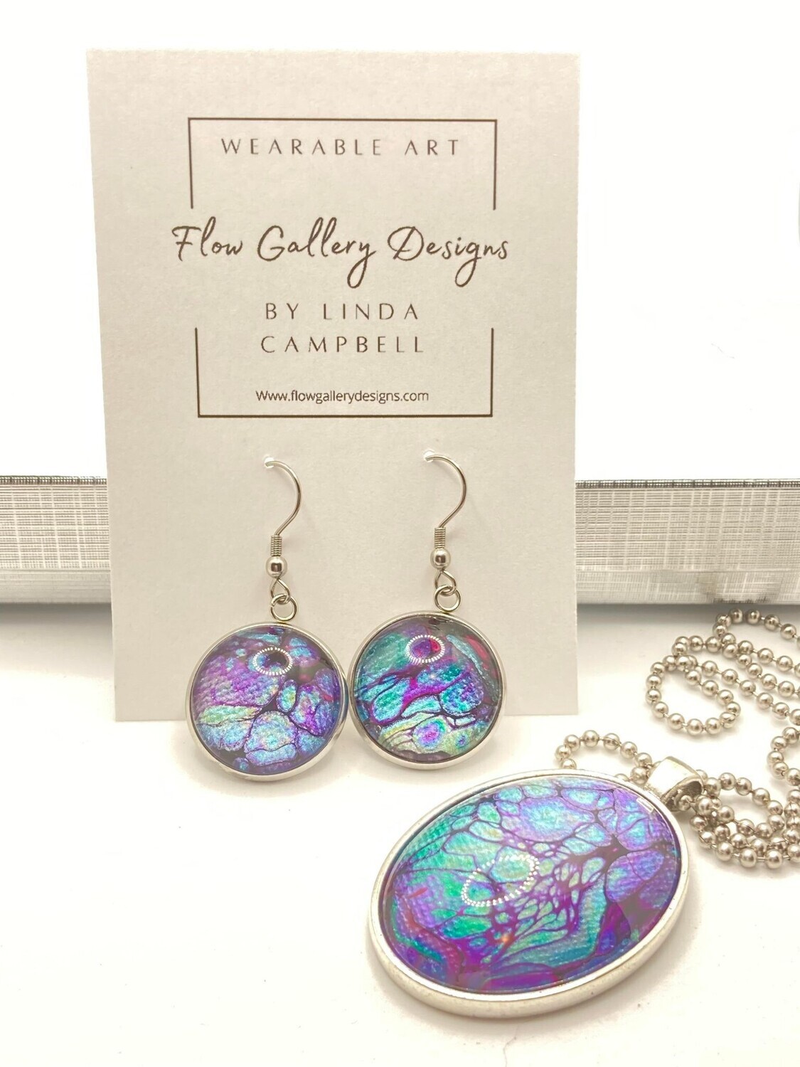 Bold and colorful paint pour design wearable art necklace and earring set