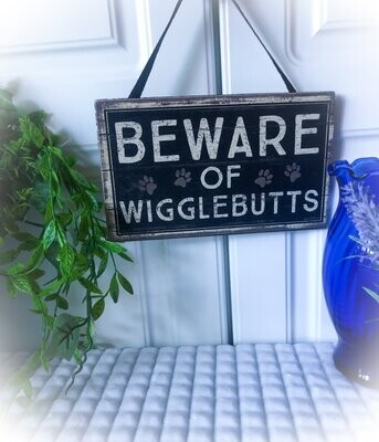Farmhouse wood hanging sign saying "Beware of wiggle Butts"
