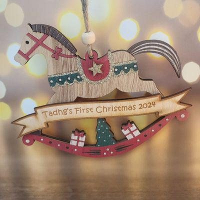Duffy &amp; Porter First Christmas Rocking Horse Decoration - A Cherished Keepsake
Celebrate your baby’s first Christmas with the Duffy &amp; Porter First Christmas Rocking Horse Decoration. This exquisite tree ornament, measuring approximately 18cm wide, is designed to capture the magic of this special milestone. Available in brown, red, and white, each rocking horse is adorned with glitter details to catch the twinkling lights of your Christmas tree.