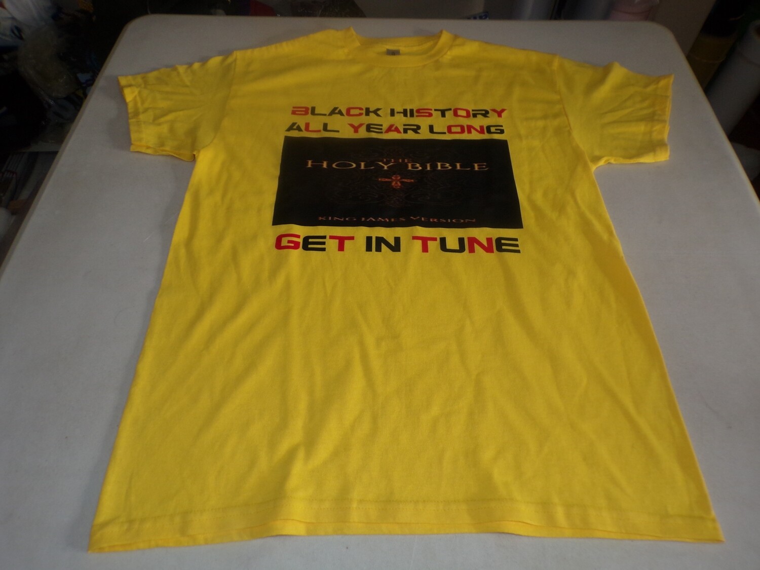Black History All Year Long The Holy Bible Get in Tune yellow tee black or red fringes.